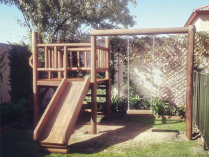 Juegos de madera para niños modelo Licanray con torre elevada, resbalín de madera y columpio lateral.